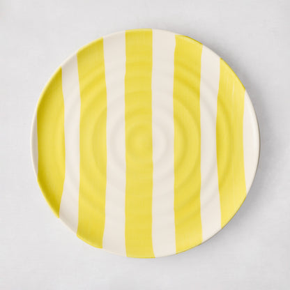 Handmade Italian ceramic salad plate with yellow vertical stripes and subtle spiral grooves.