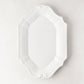 Sprezzatura white ceramic serving platter with decorative scalloped edges, 11.8"L x 8.25"W.