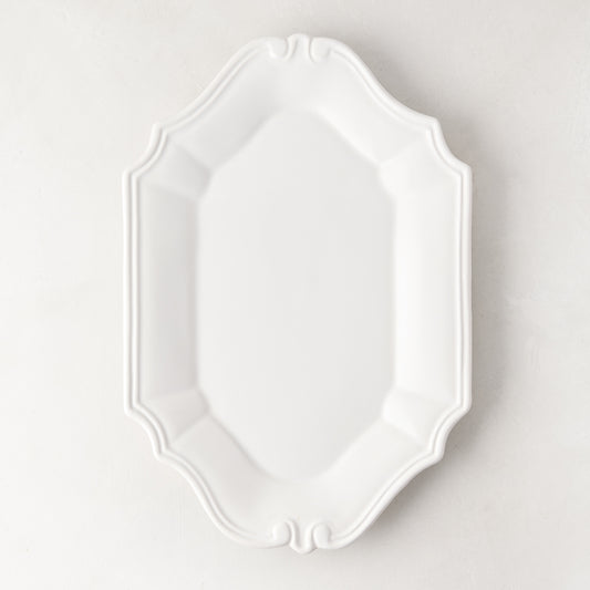 Sprezzatura white ceramic serving platter with decorative scalloped edges, 11.8"L x 8.25"W.