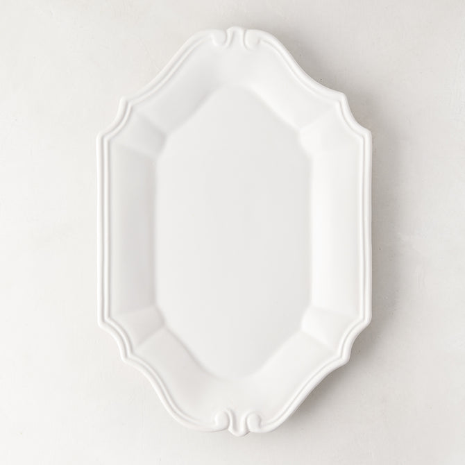 Sprezzatura white ceramic serving platter with decorative scalloped edges, 11.8"L x 8.25"W.
