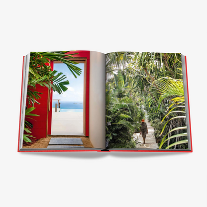 Open "St. Barths Freedom" book with red linen hardcover, showing vibrant island scenes.