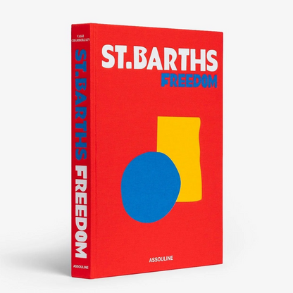 Red linen hardcover book, "St. Barths Freedom" title, with blue circle and yellow rectangle graphic.