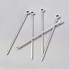 Set of six silver stainless steel cocktail picks, 3.75"L, with a ring top design.