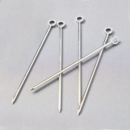 Set of six silver stainless steel cocktail picks, 3.75"L, with a ring top design.
