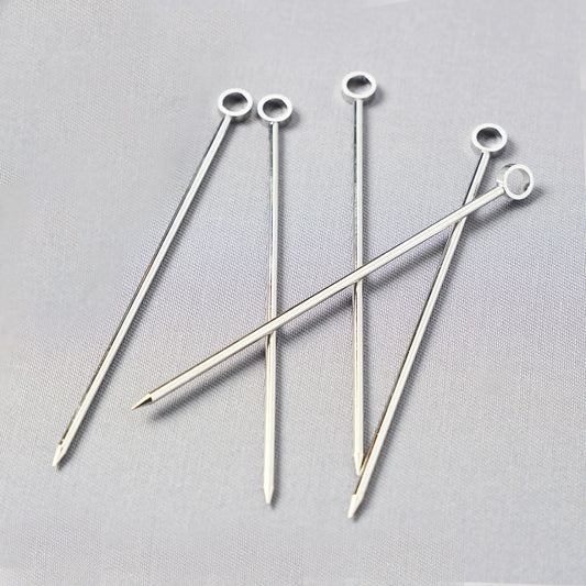 Set of six silver stainless steel cocktail picks, 3.75"L, with a ring top design.