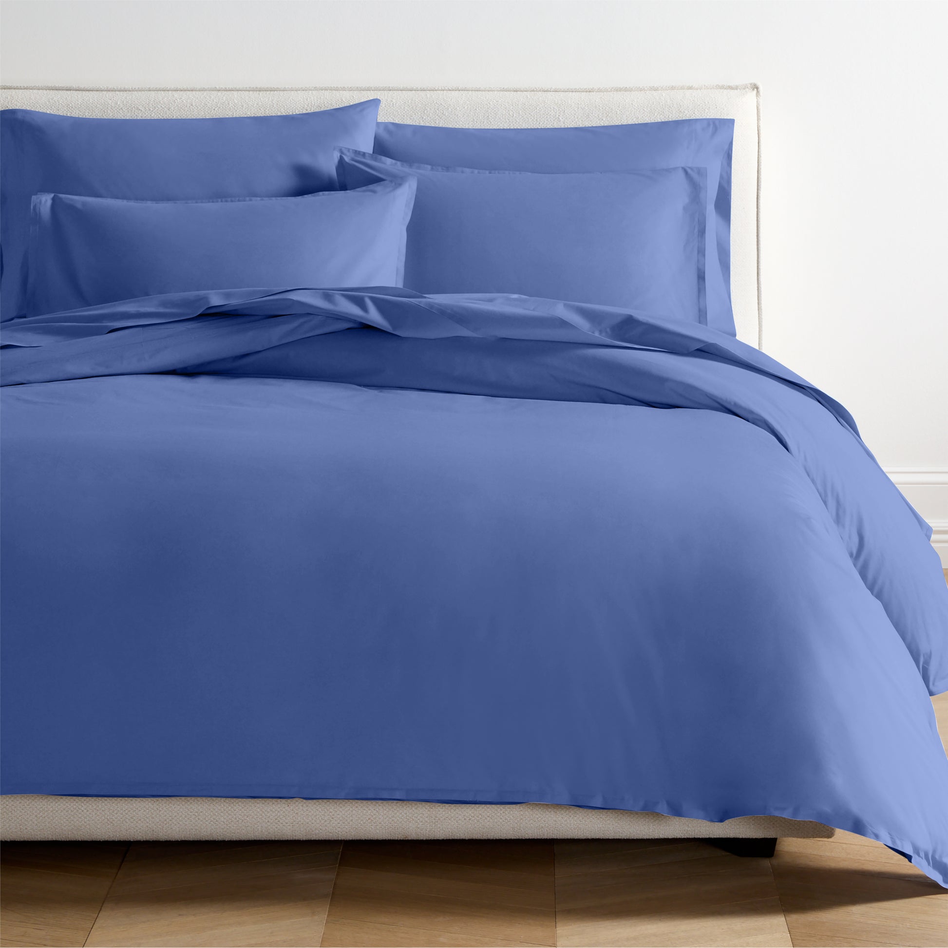 Steele Blue Italian Percale Duvet Set with duvet cover and two shams on a bed.