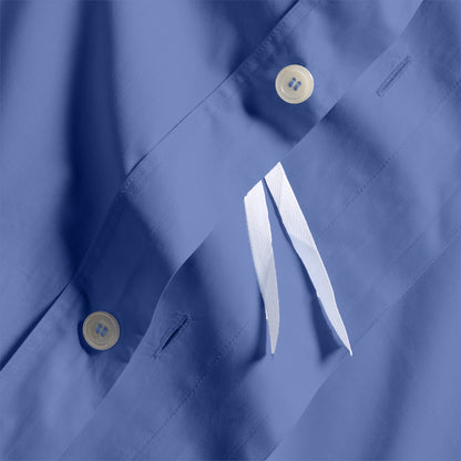 Close-up of Steele Blue Italian Percale Duvet Set with button closures and white fabric ties.