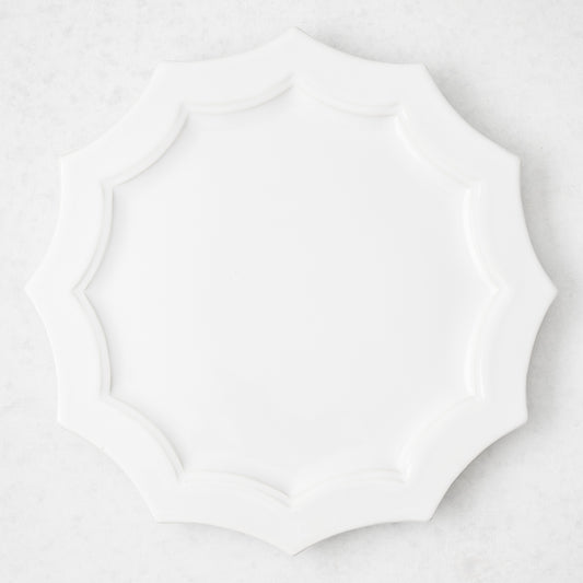 Stella 8.5-inch white ceramic dinner plate with a decorative scalloped edge, top-down view.