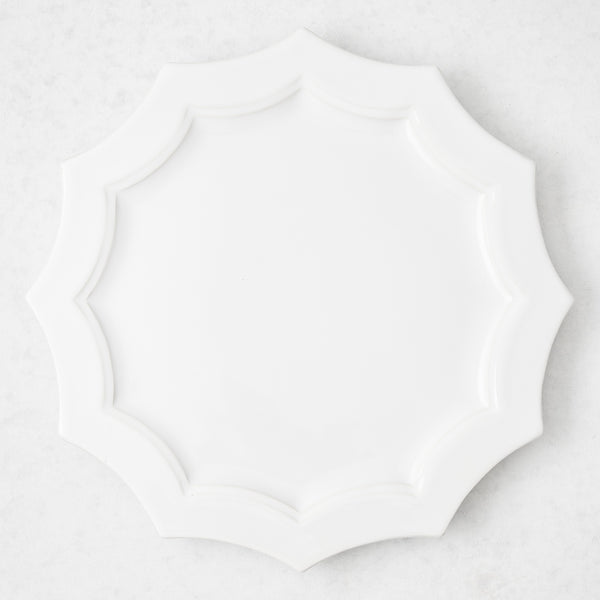 Stella 8.5-inch white ceramic dinner plate with a decorative scalloped edge, top-down view.