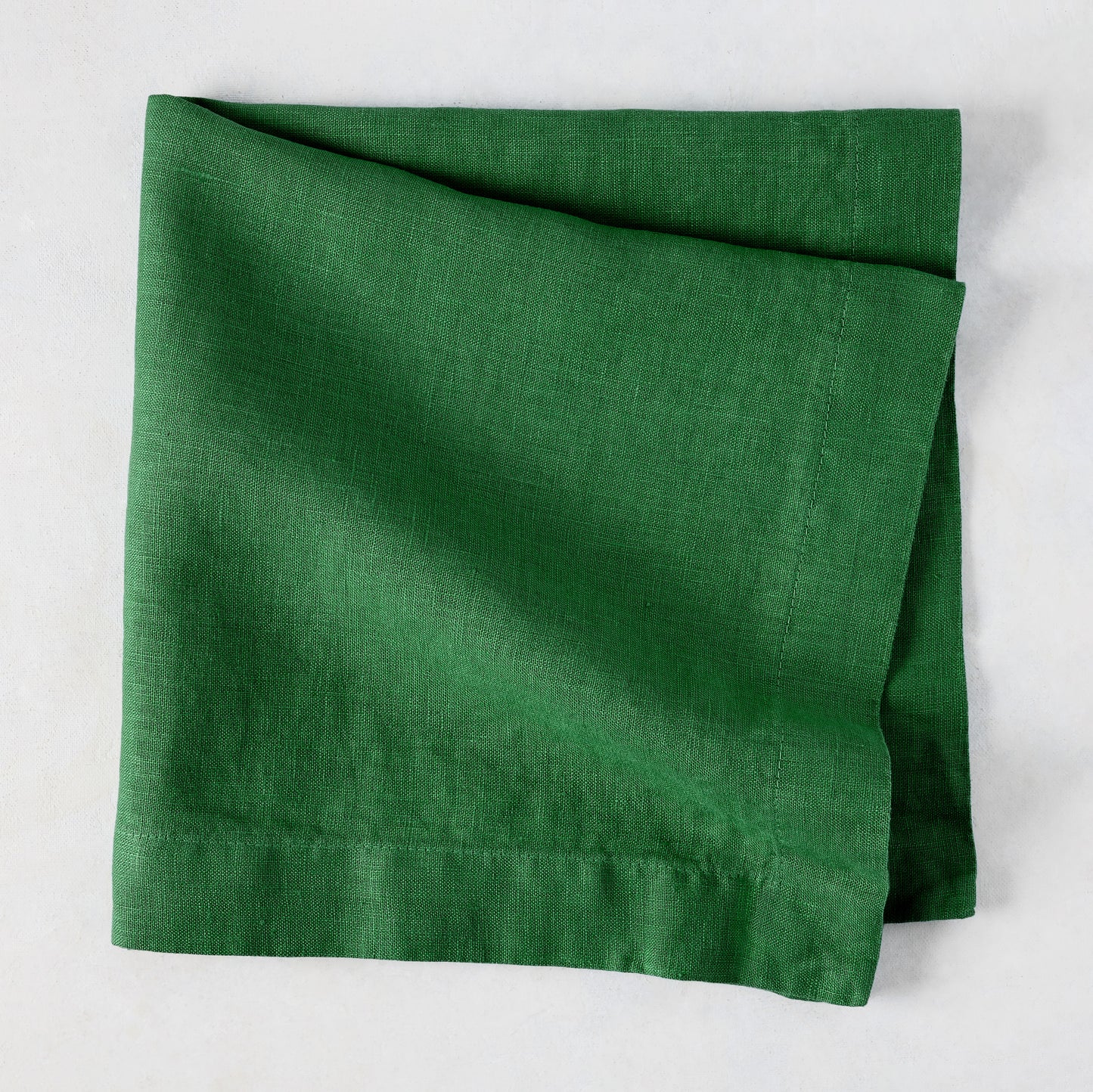 Stem HG Signature hand-dyed Kelly Green linen napkin, 22-inch square, folded.