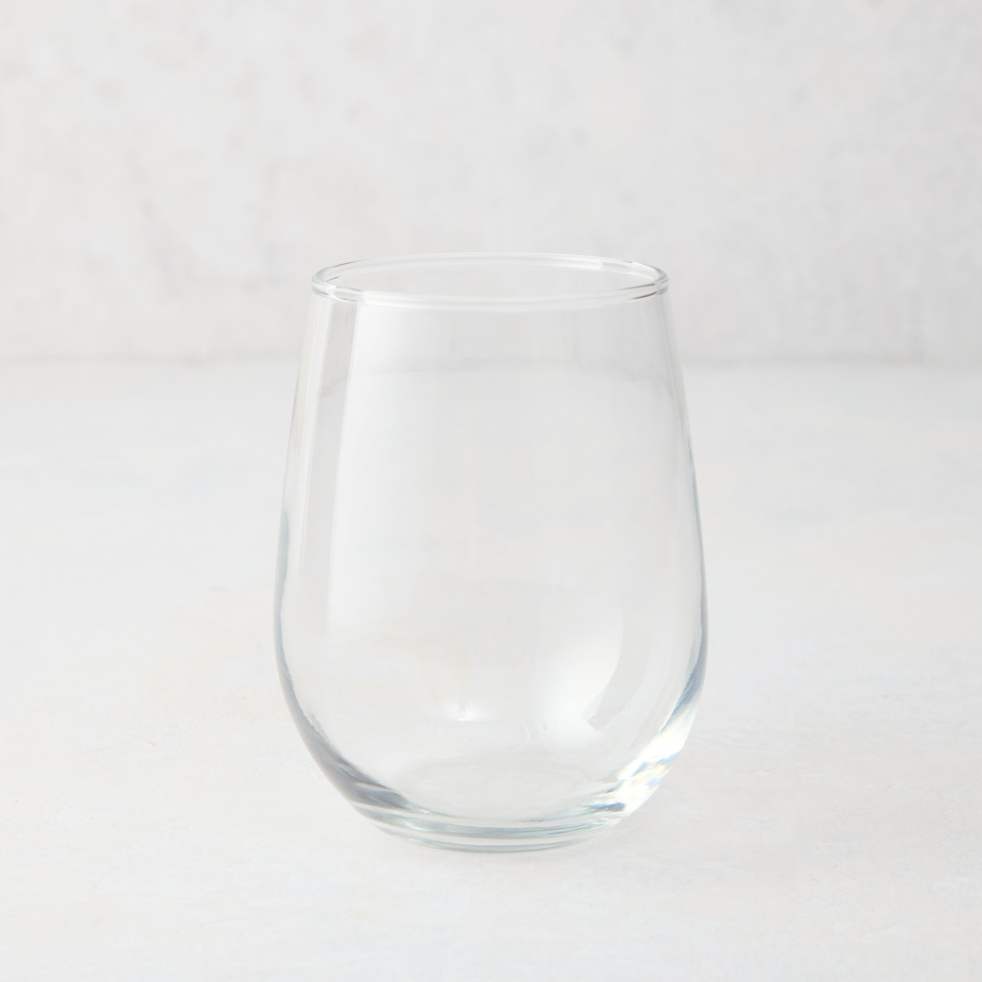 Clear glass stemless all-purpose wine glass, 16.75 oz, from Hudson Grace collection.