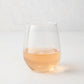 Clear stemless all-purpose glass filled with light pink rosé wine, 16.75 oz. capacity.