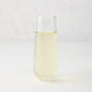 Clear Hudson Grace stemless champagne flute with sparkling light yellow liquid.