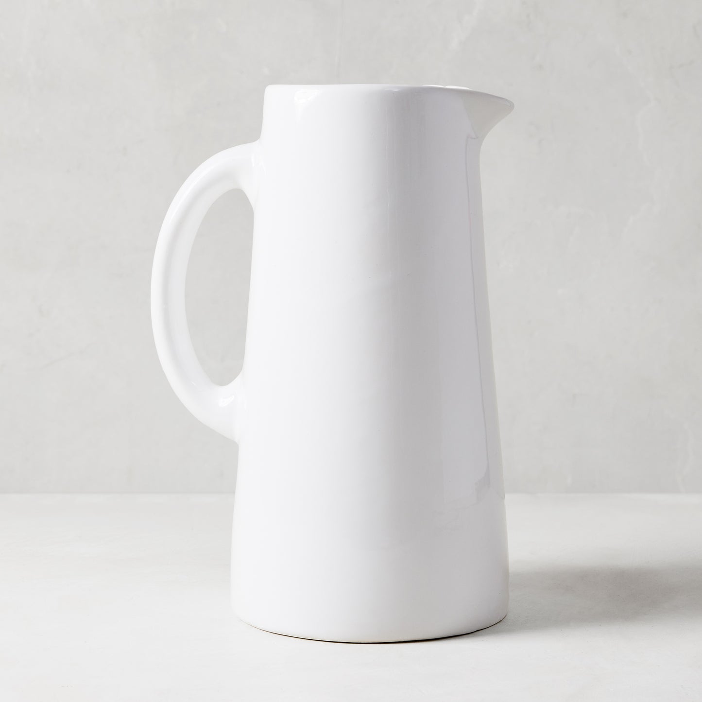 Large Stinson white ceramic pitcher with handle and spout, handmade in Italy.