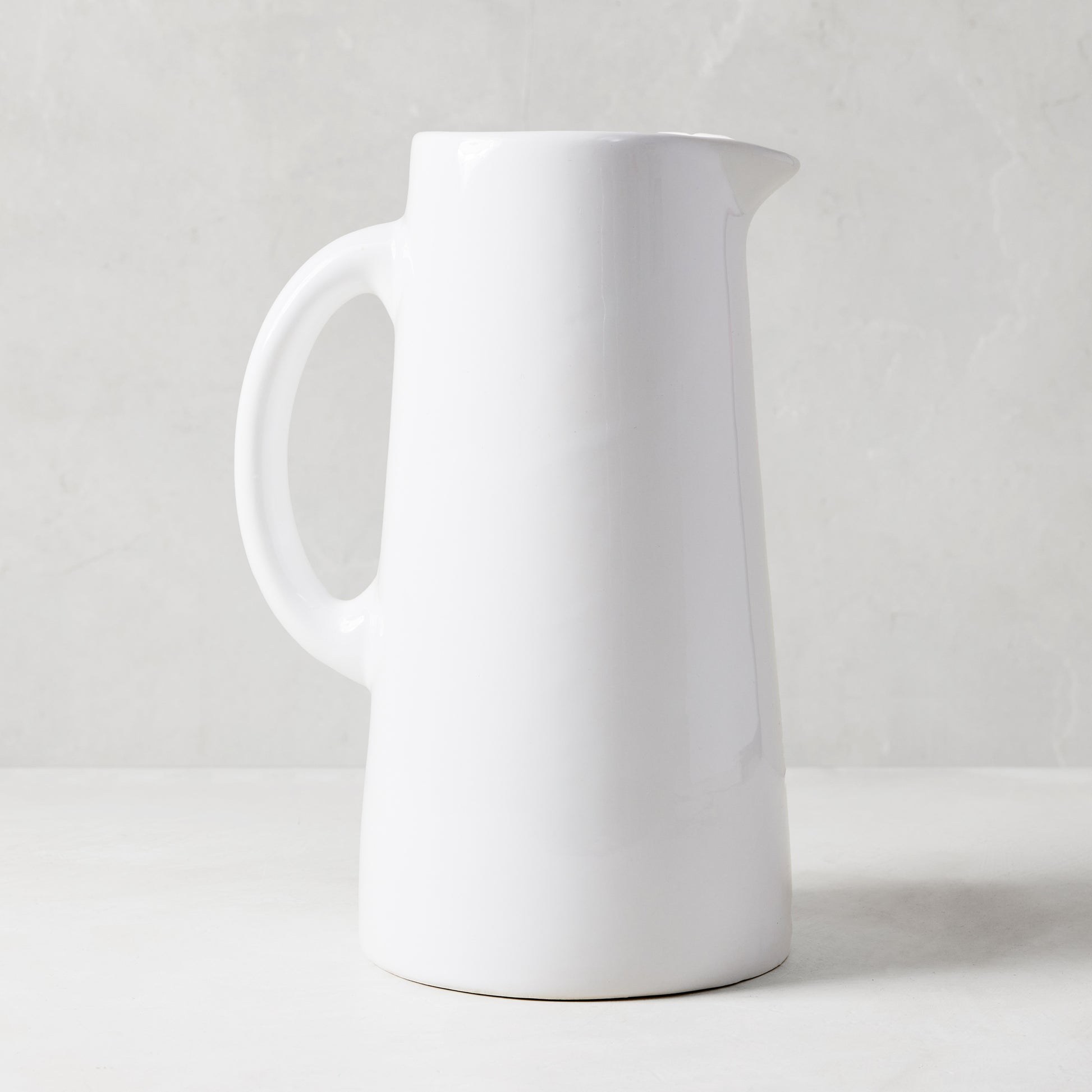 Large Stinson white ceramic pitcher with handle and spout, handmade in Italy.