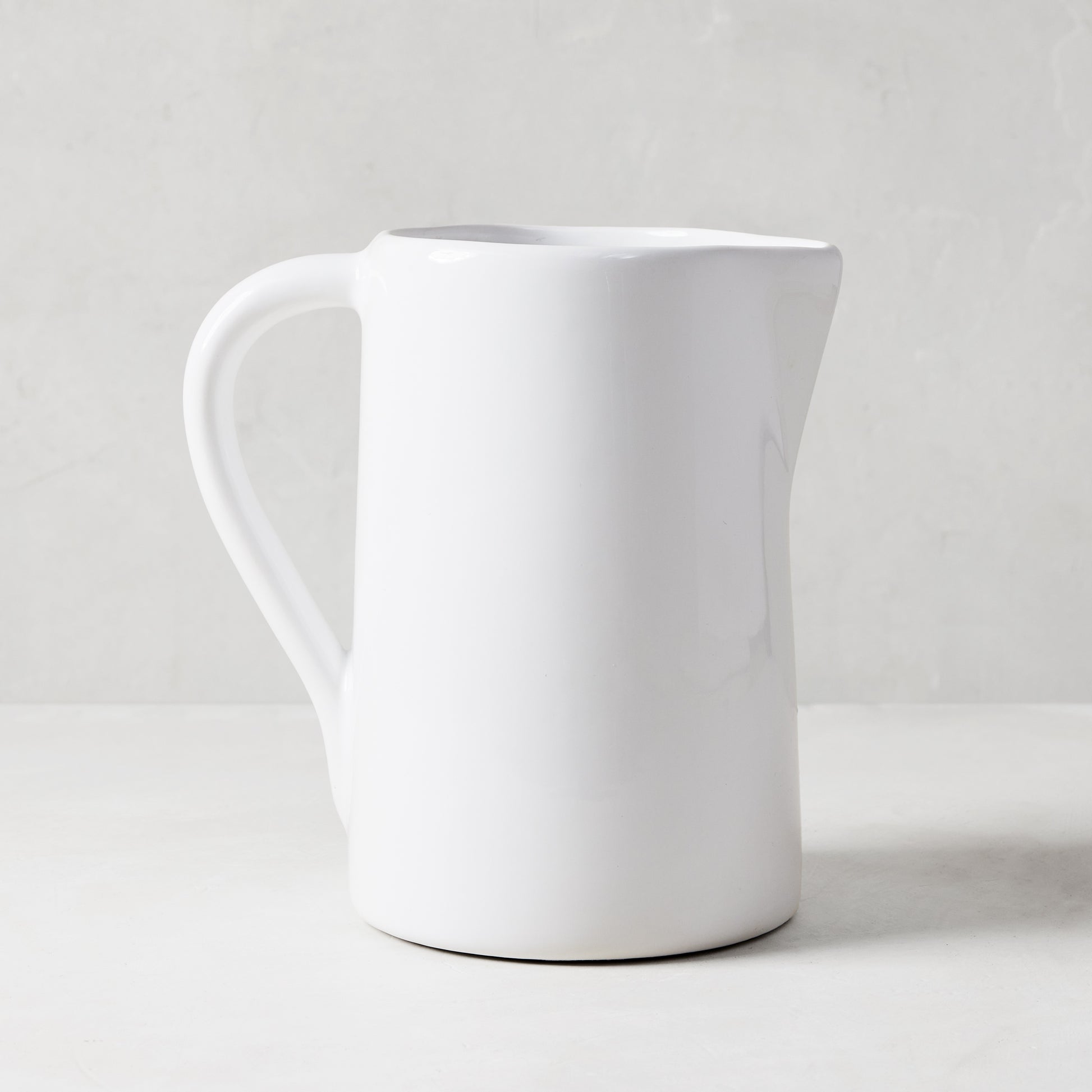 Stinson Medium Ceramic Pitcher, handmade white Italian ceramic with large handle and spout.