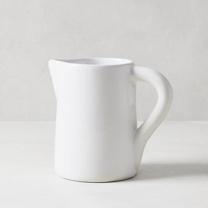 White ceramic Stinson small pitcher with large handle and spout, handmade in Italy.