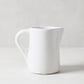 Stinson Small Ceramic Pitcher, handmade white Italian ceramic with large handle and spout.