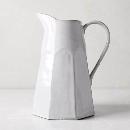 Stone grey terracotta pitcher, hand-glazed, with a faceted body and handle.