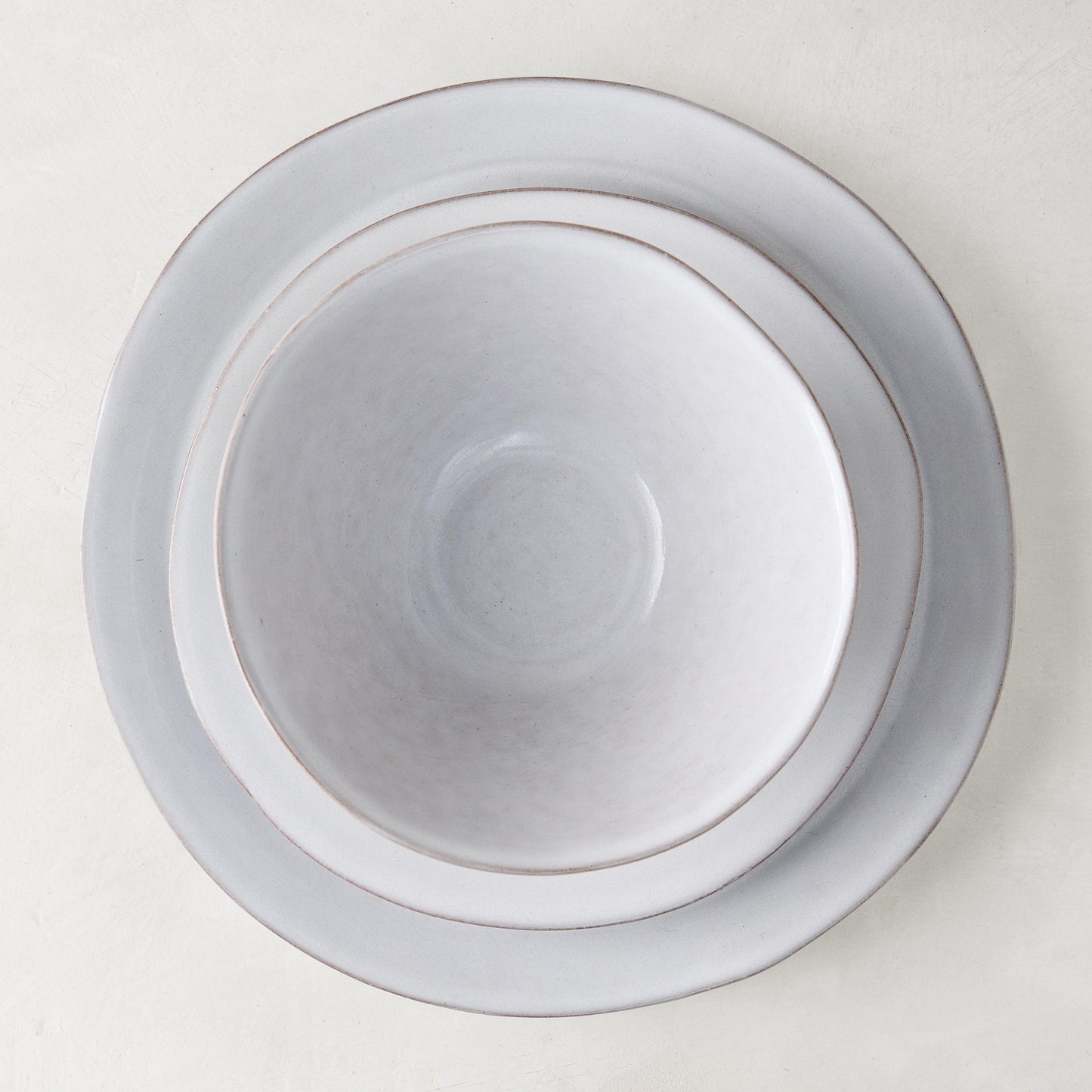 Stone grey hand-glazed terracotta dinner plate with a matching bowl, 10.75" diameter.