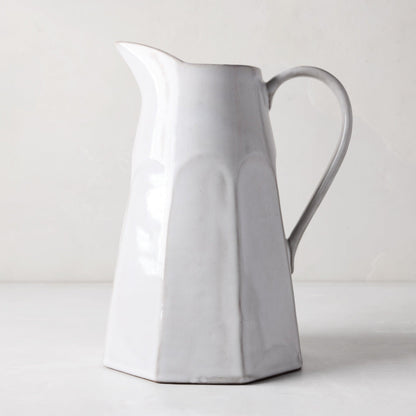 Stone grey terracotta pitcher, hand-glazed, with a faceted body and handle.
