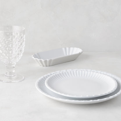 White melamine Street Eats hot dog holder, two scalloped plates, and a textured glass.