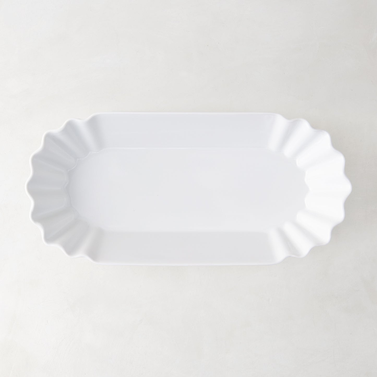 White Melamine Street Eats Hot Dog Holder, 9"L x 4"W, with scalloped edges.