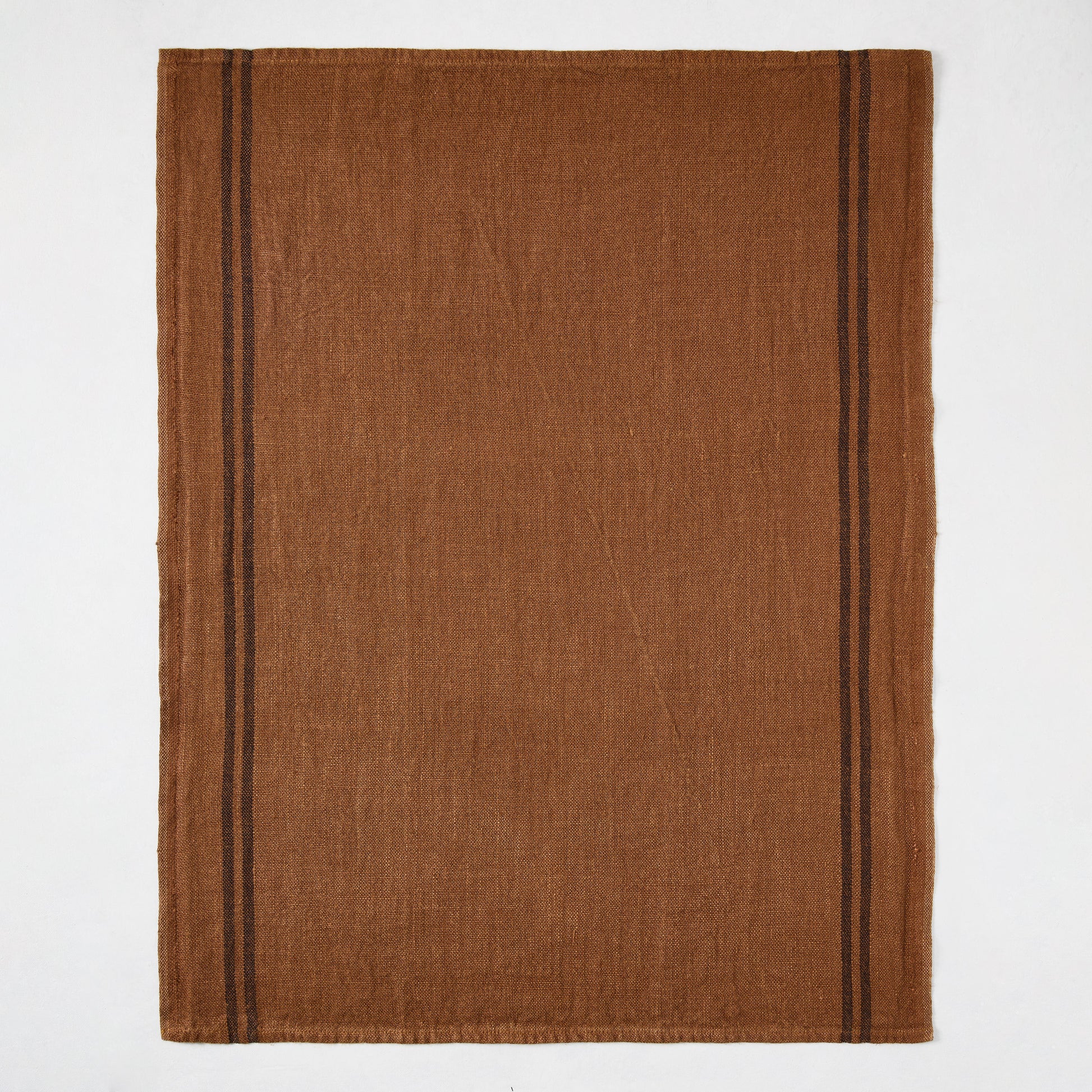 Brown French linen hand towel with two thin black stripes on each side.