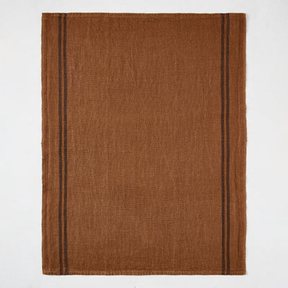 Brown French linen hand towel with two thin black stripes on each side.