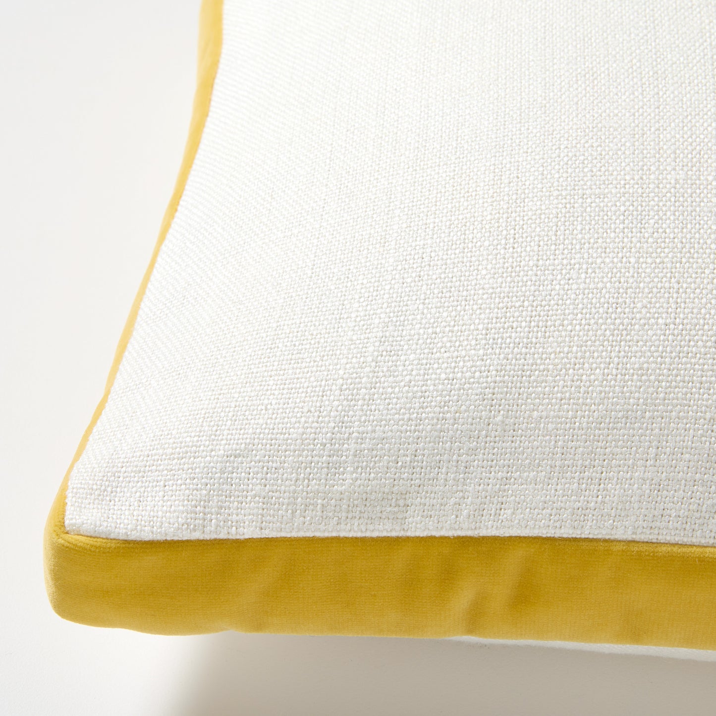 Sun Yellow Velvet Gusseted Lumbar Pillow, white linen top, yellow velvet bottom, 20"L x 14"H.