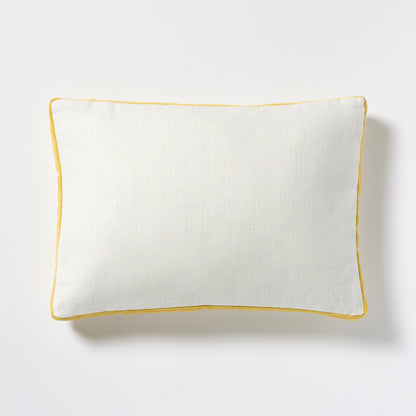White linen lumbar pillow with sun yellow velvet gusseted trim.