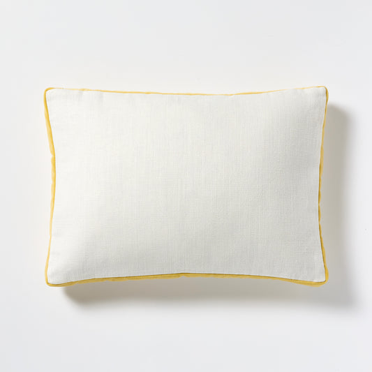 White linen lumbar pillow with sun yellow velvet gusseted trim.