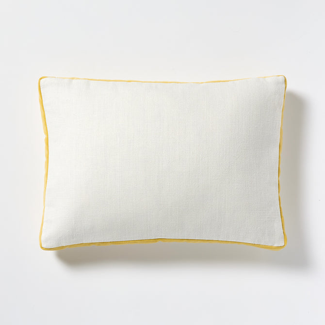 White linen lumbar pillow with sun yellow velvet gusseted trim.