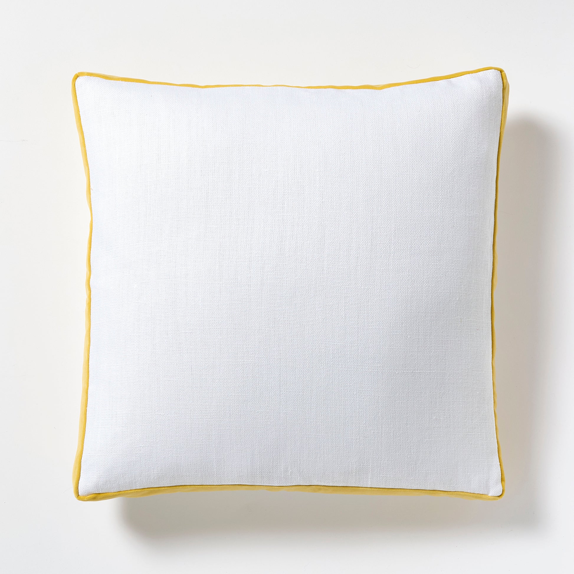 White linen square pillow with sun yellow velvet gusseted trim.