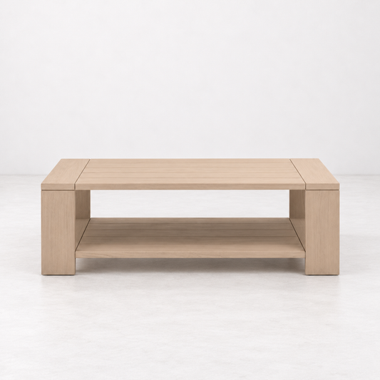 Rectangular washed teak outdoor coffee table with a lower storage shelf and solid wood construction.
