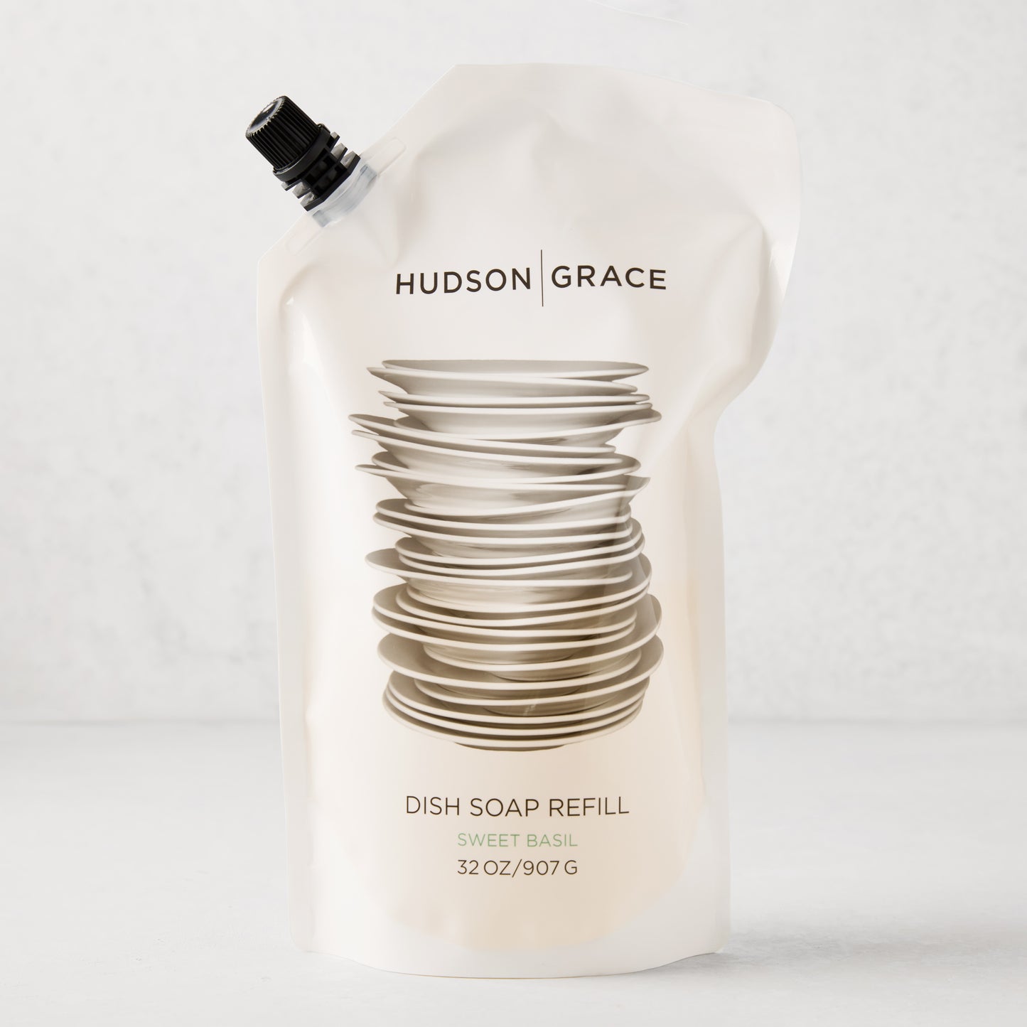 Hudson Grace Sweet Basil Dish Soap Refill pouch, 32oz, with stacked dishes graphic.