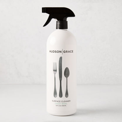 HG Sweet Basil Surface Cleaner, 32oz white spray bottle with black top and cutlery graphic.