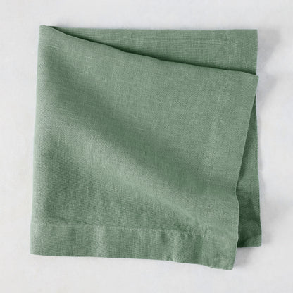 Swiss Chard HG Signature hand-dyed sage green linen napkin, folded, with visible texture and mitered corners.