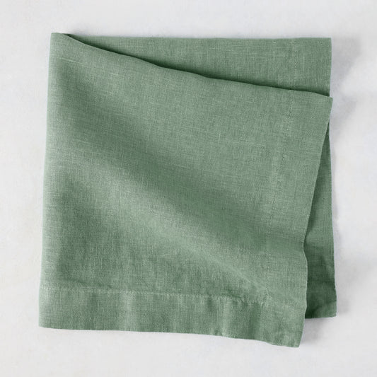 Swiss Chard HG Signature hand-dyed sage green linen napkin, folded, with visible texture and mitered corners.