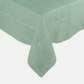 Swiss Chard HG Signature Hand-dyed Linen Tablecloth in a soft green hue, showing mitered corner detailing.