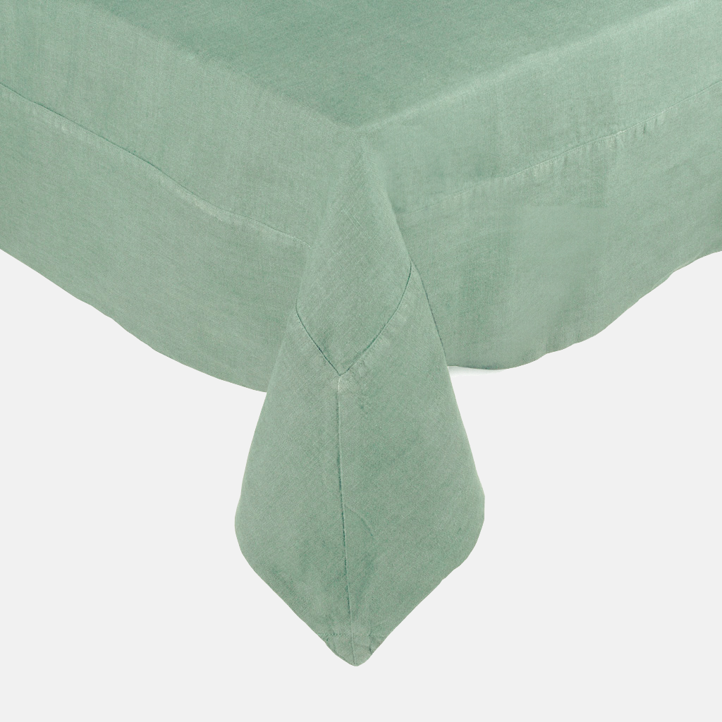 Swiss Chard HG Signature Hand-dyed Linen Tablecloth in a soft green hue, showing mitered corner detailing.