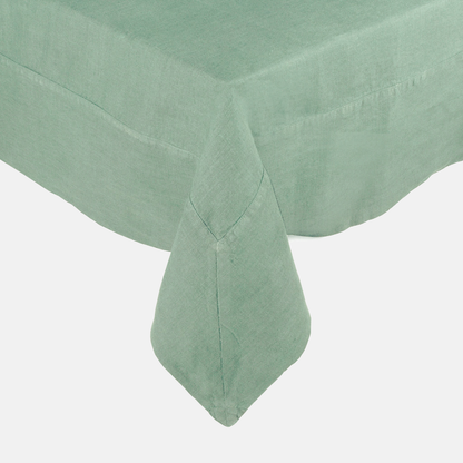 Swiss Chard HG Signature Hand-dyed Linen Tablecloth in a soft green hue, showing mitered corner detailing.