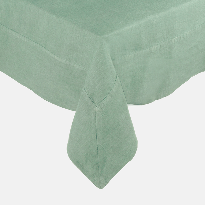 Swiss Chard HG Signature Hand-dyed Linen Tablecloth in a soft green hue, showing mitered corner detailing.