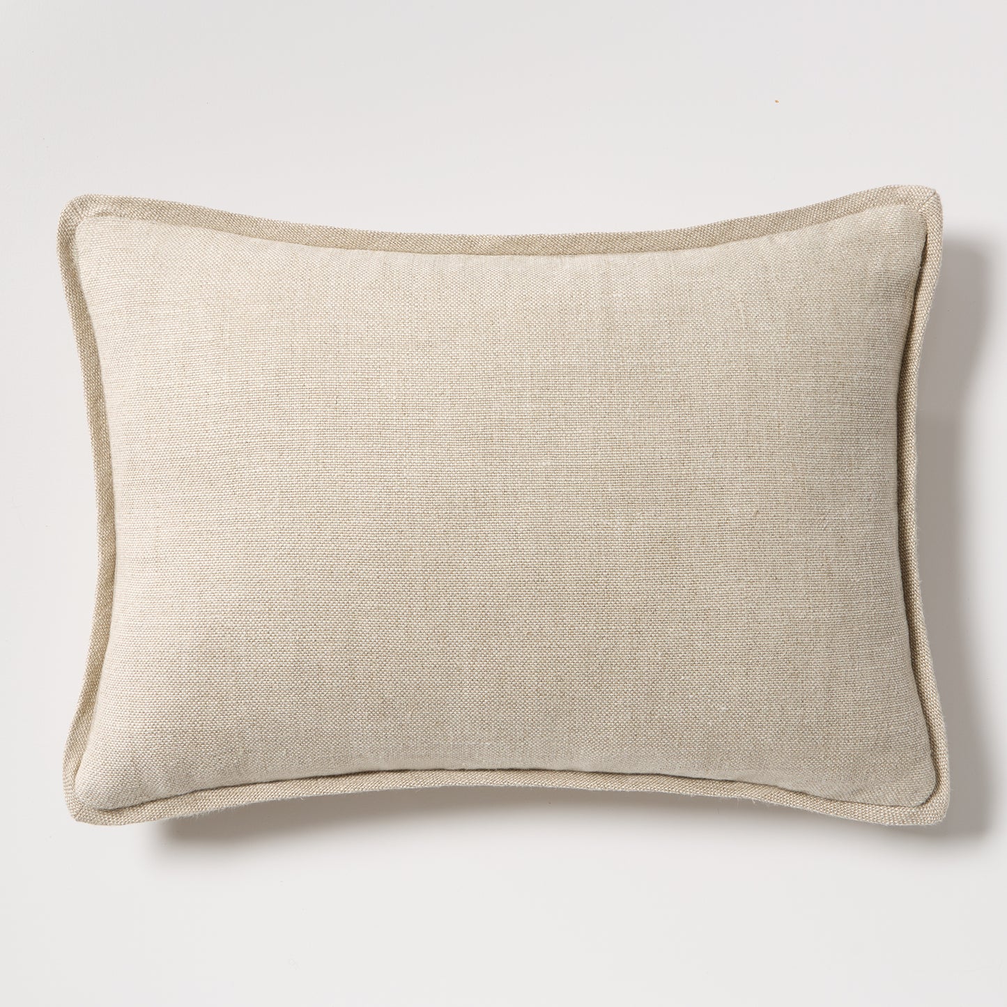 Tan reversible velvet and linen lumbar pillow, 20"L x 14"H, with a subtle texture and piped edges.