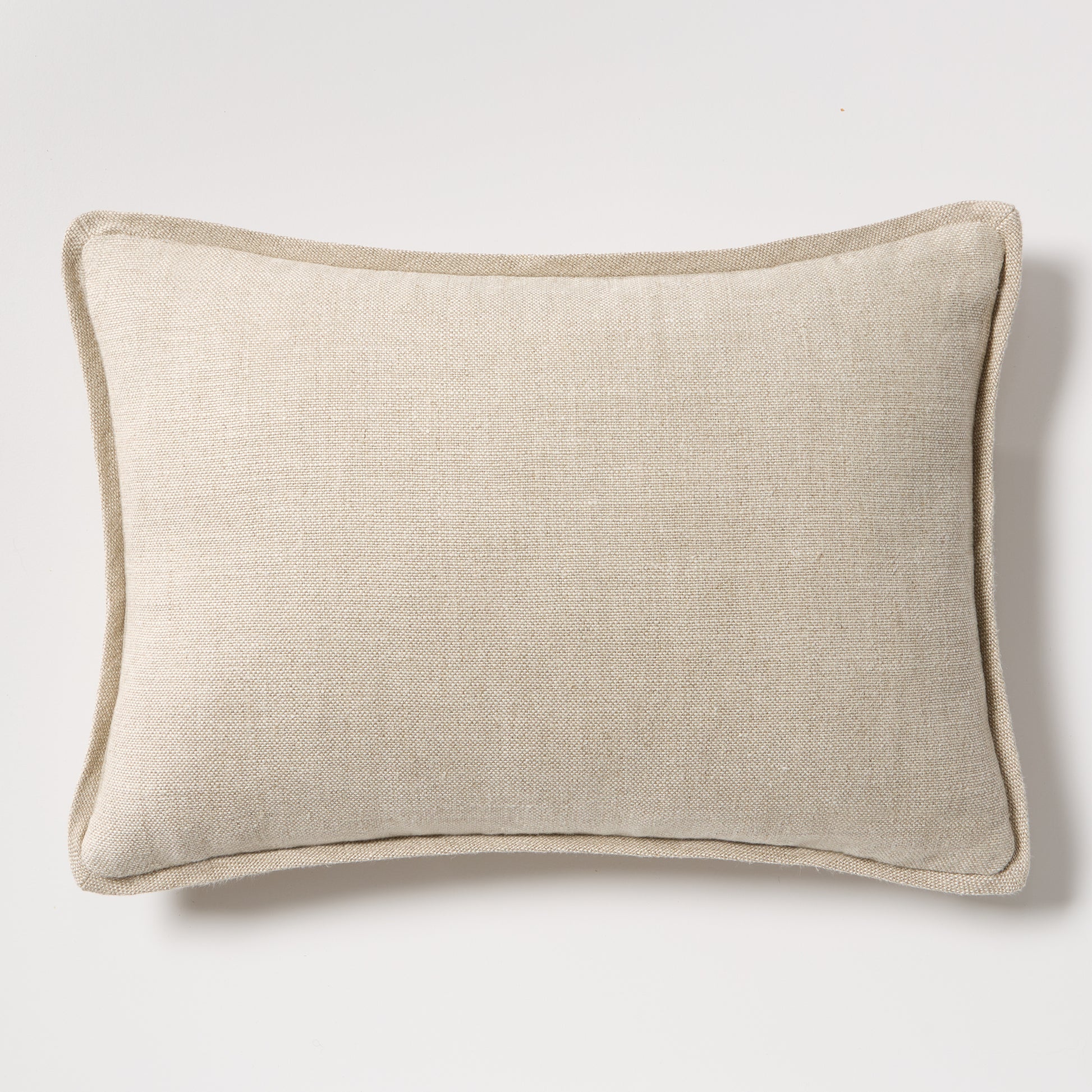 Tan reversible velvet and linen lumbar pillow, 20"L x 14"H, with a subtle texture and piped edges.