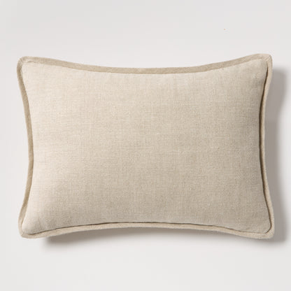 Tan reversible velvet and linen lumbar pillow, 20"L x 14"H, with a subtle texture and piped edges.