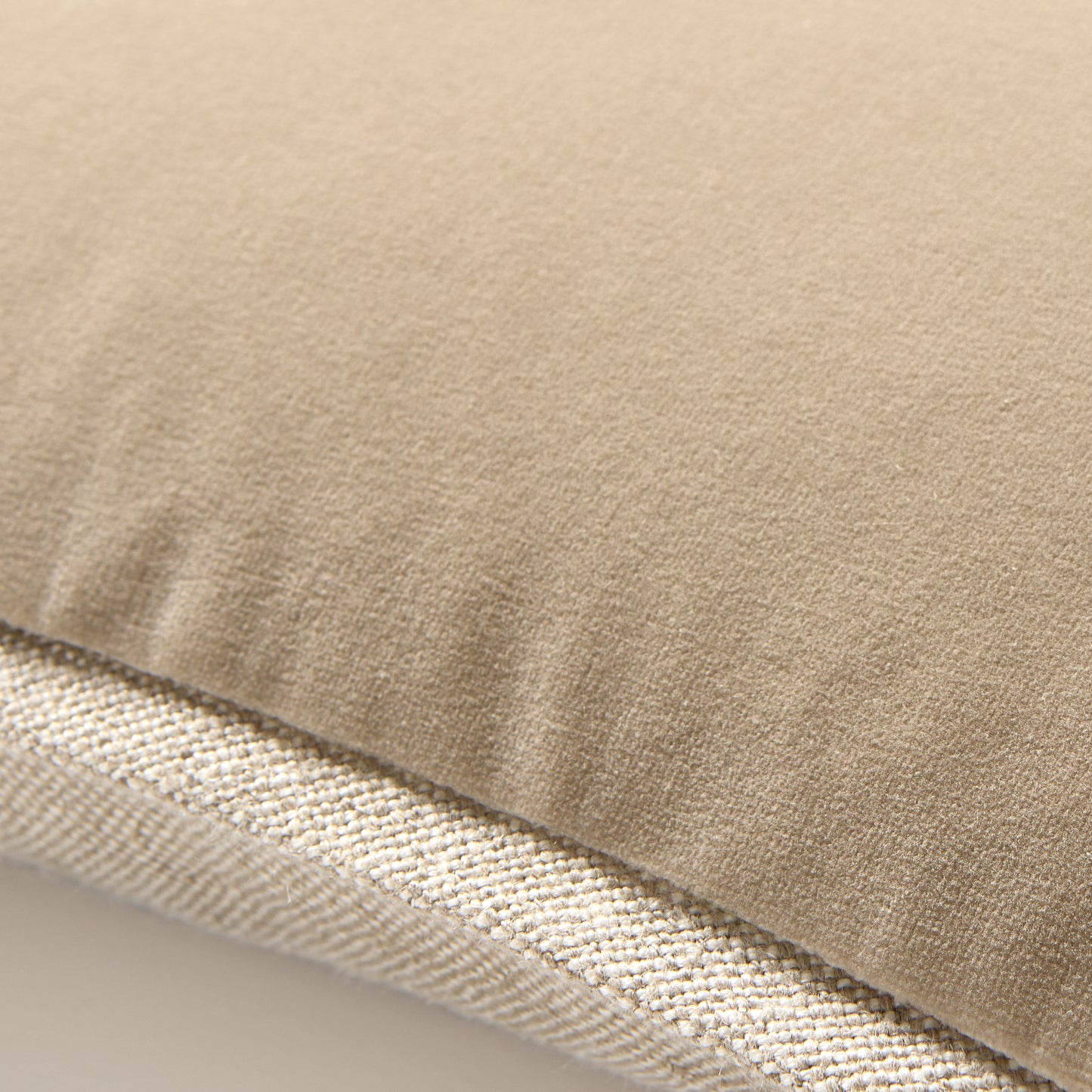 Tan reversible velvet and linen lumbar pillow, 20"L x 14"H.