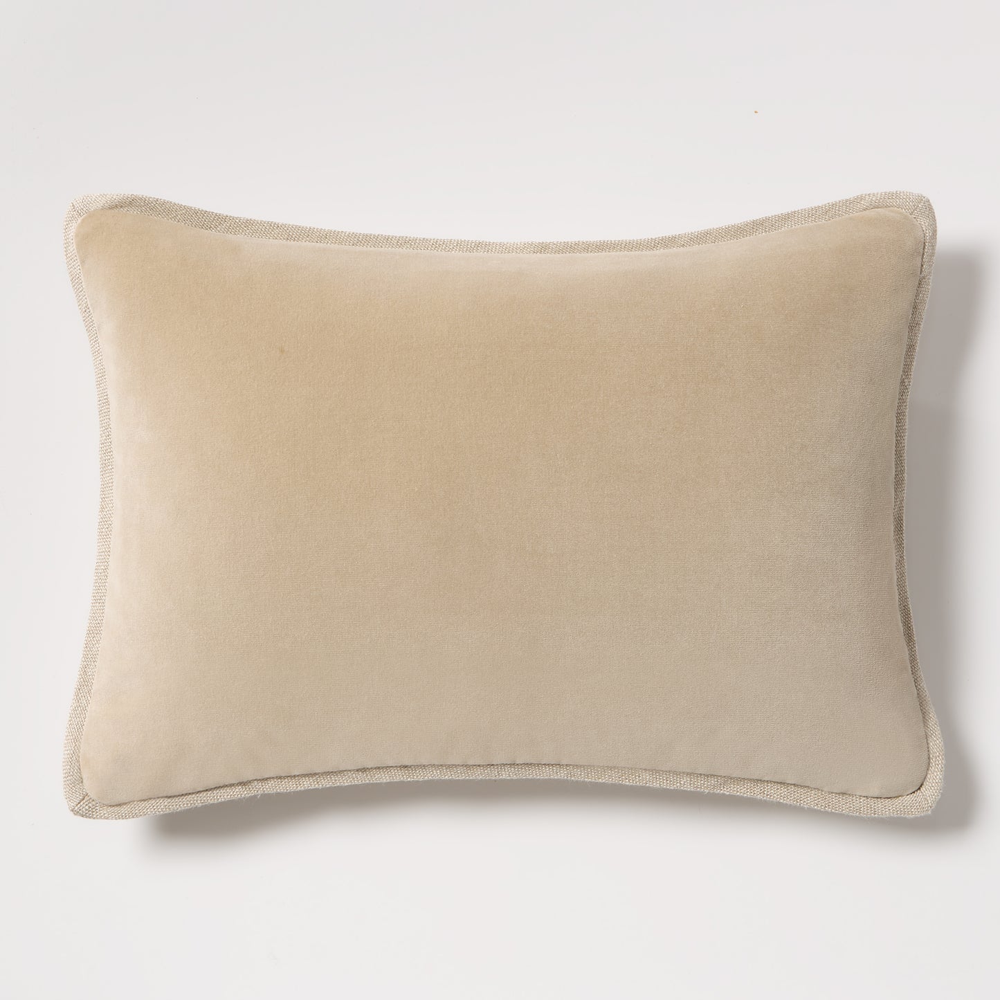 Tan reversible velvet and linen lumbar pillow, 20"L x 14"H, with visible linen piping.