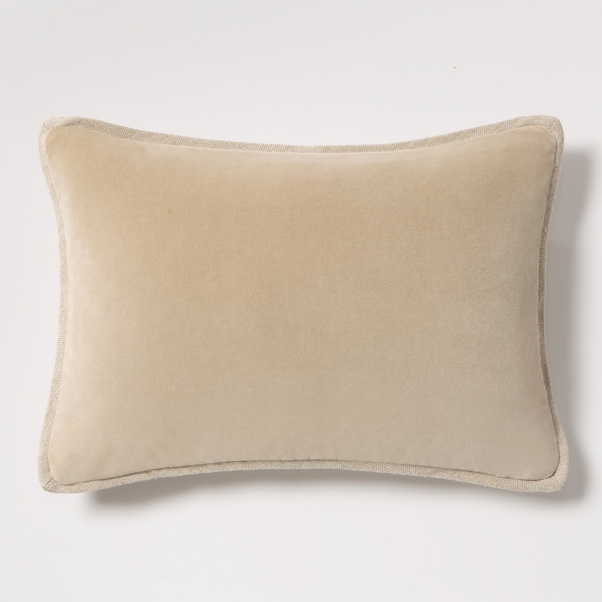 Tan reversible velvet and linen lumbar pillow, 20"L x 14"H, with visible linen piping.