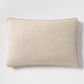 Tan velvet gusseted and linen lumbar pillow, 20"L x 14"H, with piped edges.
